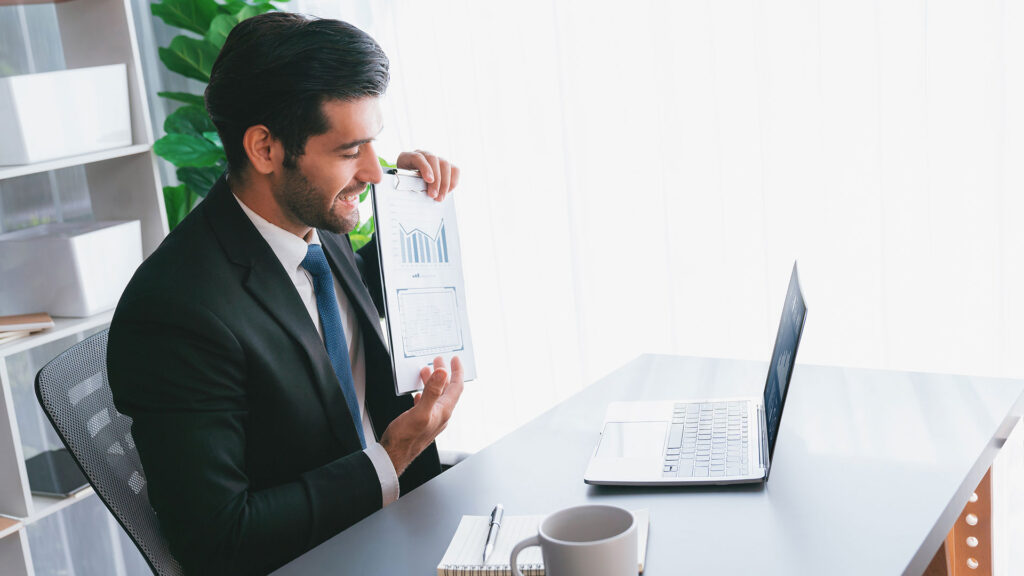 person in front of a computer sitting at adesk
